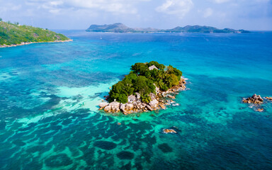 Drone view from above at a tropical beach in the Seychelles, Anse Volbert beach Praslin
