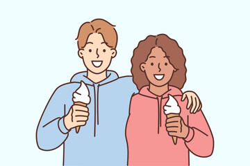 Smiling interracial couple hug eat ice cream
