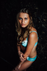 Fototapeta premium tanned girl in blue lingerie. beautiful figure