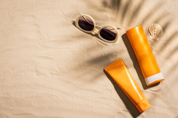 Sunblock lotion bottles on sandy beach