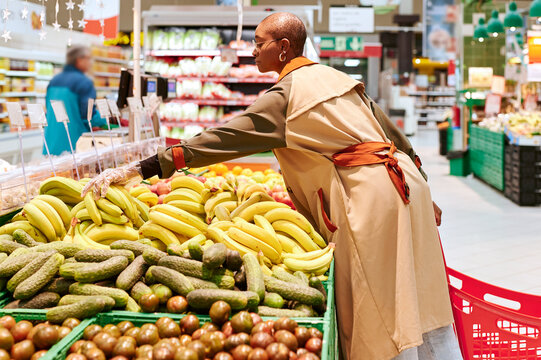 Woman buying bananas in a supermarket