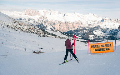 Young man anjoying the amazing view of Dolomity superski mountain resort with torri del sella, piz...
