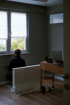 A male worker makes a marking for the heating system in an apartment
