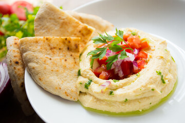 Hummus is a cream of chickpeas cooked with lemon juice, which includes tahini paste and olive oil, which, depending on the local variant, can also include other ingredients such as garlic or paprika.