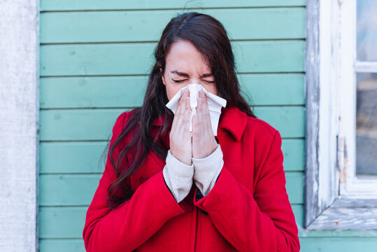 Woman Blowing Her Nose With A Tissue