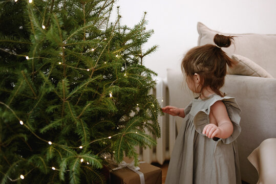 Baby girl decorates Christmas tree