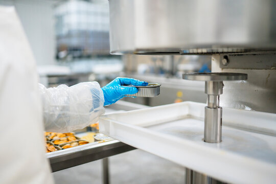 Crop worker sealing can of mussels
