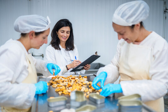 Content quality inspector watching mussels canning
