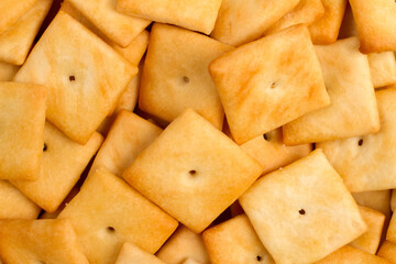 Small crispy cookie crackers close-up. Square salted biscuits.