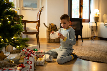 Child opening his Christmas presents