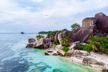 Drone view from above at a tropical beach in the Seychelles, Anse Source d'Argent white tropical...