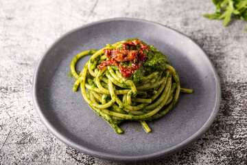 Gragnano spaghetti with homemade rocket pesto and dried tomatoes. Dish suitable for adults and...