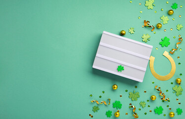 Golden Horseshoe, Gold Coins and Clover Leaves Shamrocks on Green Mint Background.