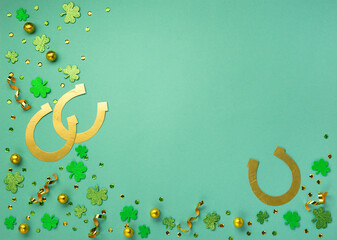 Golden Horseshoe, Gold Coins and Clover Leaves Shamrocks on Green Mint Background.