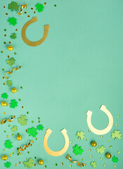 Fototapeta Golden Horseshoe, Gold Coins and Clover Leaves Shamrocks on Green Mint Background. obraz