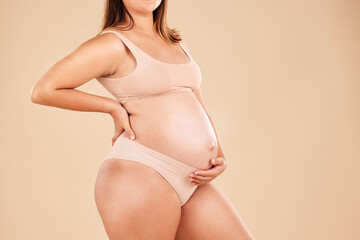 Woman, body or holding pregnancy stomach in underwear on studio background protection, love or baby...