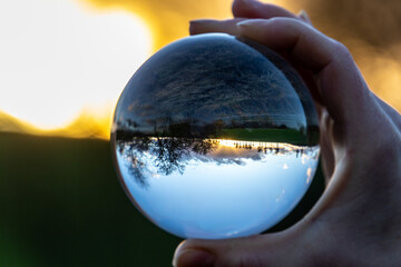 crystal ball in hand shows nature