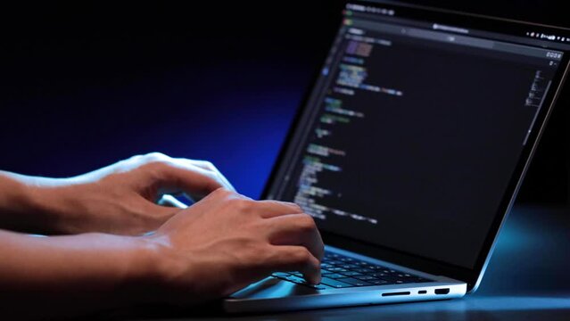 closeup of hands typing codes at late night