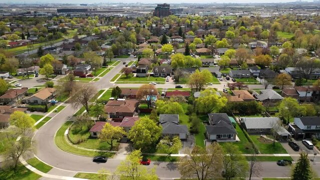 Drone flying towards suburban Brampton neighborhood in the summer.
