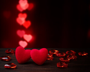 Velvet heart and heart shaped bokeh on dark background. Perfect for Valentine's Day.