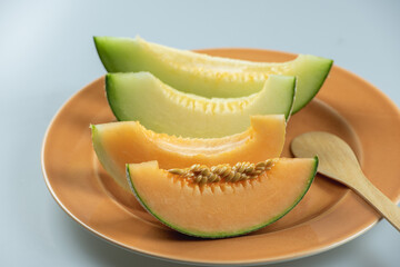 Honeydew melon and Japanese melon slice fresh ripe orange and sweet green slice lay on leaf in plant. Melon or cantaloupe is sweet fruit dessert.