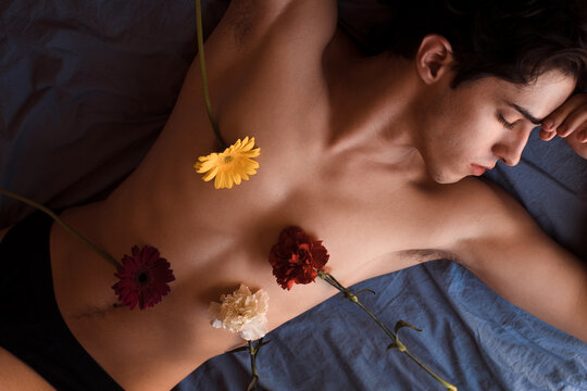 Non-binary person with flowers on their body
