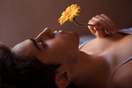 Non-binary romantic person with flower