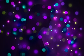 Silhouette of a woman surrounded by lights