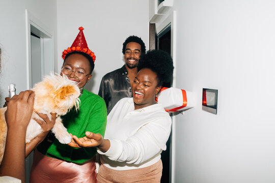 Friends Entering Apartment with Christmas Gifts 
