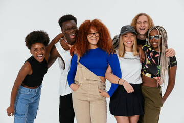 Cheerful diverse friends looking at camera in studio