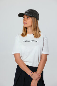 Blonde woman in cap posing in studio