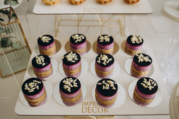 Wedding decorations. Reception. Buffet. Fruits and cheese on plates with bread in boxes. Food bar decorated by flowers and lanters
