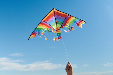 Hand holding a colorful kite