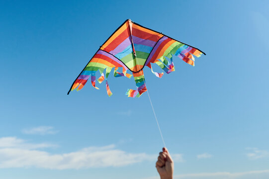 Hand holding a colorful kite