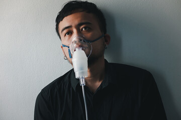 Asian boy wearing oxygen mask