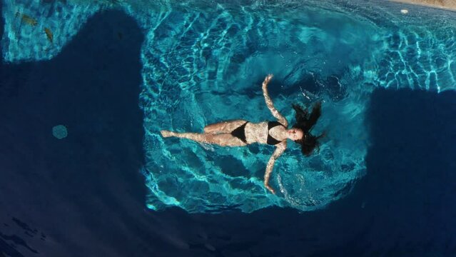 girl swimming in the pool top view