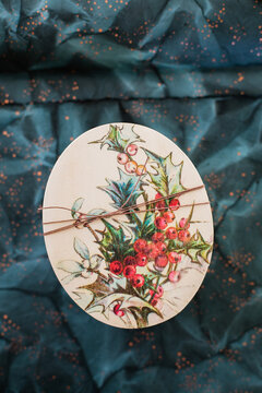 Oval-shaped Christmas Gift Box with Holly Design Tied with String