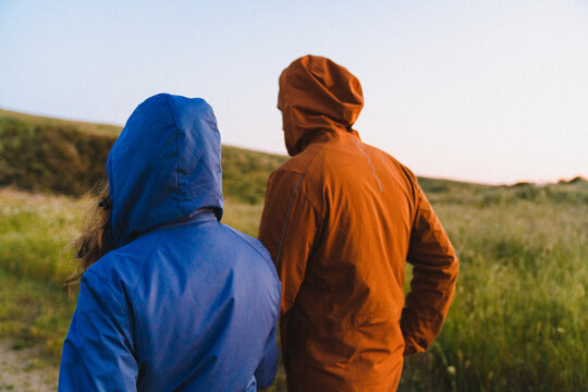 Couple Walking Wearing Hooded Jackets