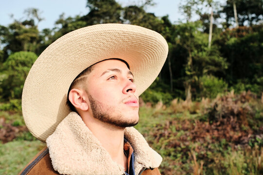 Portrait of a young gay man wearing a hat
