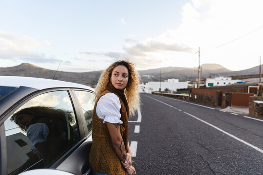 Woman Leaning Against Car