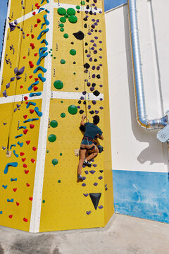 Male athlete climbing wall