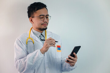 Asian man in Doctor uniform on white background in hospital 