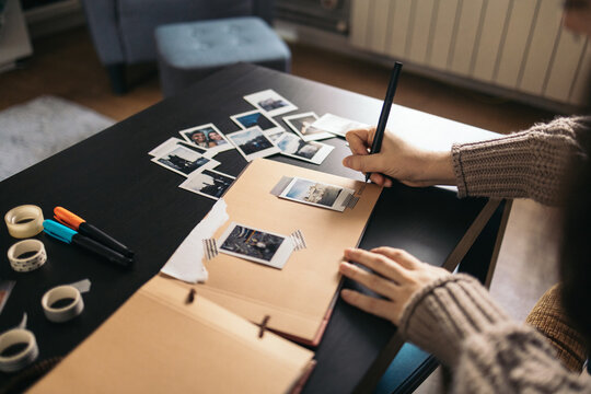 Woman making a scrapbook with polaroid photos