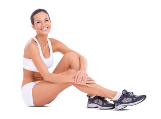 An attractive fit woman in exercise clothing sitting on the floor isolated on a PNG background.