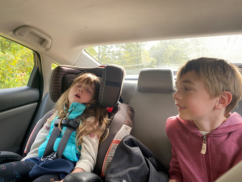 funny ugc moment of a toddler sleeping in the car next to her brother