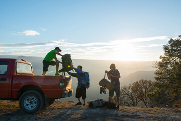 A group of friends downloading backpacks from a pick up in El PeÃƒÂ±on de los Camachos, Jalisco, Mexico.