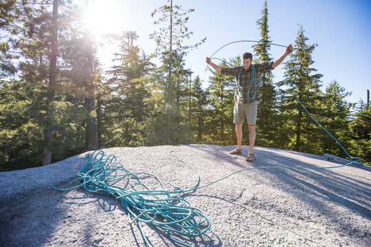 Rock climber coiling rope