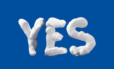 Yes word made of shaving foam letters on blue background