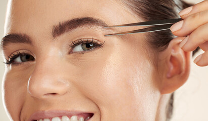 Face, beauty and woman portrait with tweezer for eyebrow cleaning or hair removal in studio. Happy...