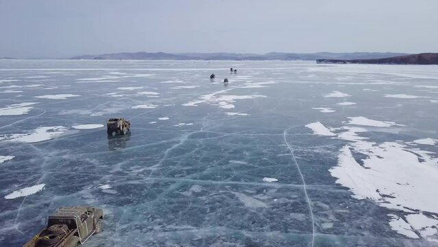 aerial view of amazing cinematic rally scene on frozen lake baikal in russia